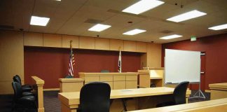Sovereignty Showdown: ICC vs. America Interior view of an empty courtroom with wooden furniture and American flags