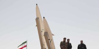 Leader Down — Revenge Promised soldiers stand beside large missiles at outdoor display