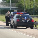Highway Pullover Becomes Multi-Agency Manhunt Police officer conducting a traffic stop on a highway