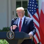 Classified Intel Teases a Stark Showdown man at presidential podium speaking outdoors