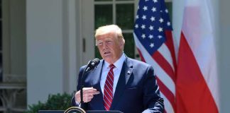 man at presidential podium speaking outdoors