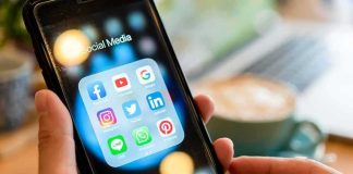 Addiction Design? Meta’s Pricey Escape Hands holding a smartphone showing social media app icons