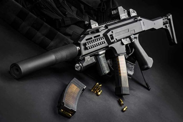 shutterstock_1512787109 Submachine gun with suppressor and magazines on dark surface