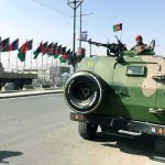 Ideology Over Bullets Inside Iran’s Guard Armored military vehicle with soldier manning a mounted gun on city street