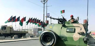 Ideology Over Bullets Inside Iran’s Guard Armored military vehicle with soldier manning a mounted gun on city street