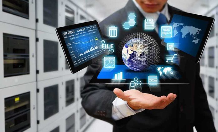 shutterstock_152663261 Businessperson holding a digital tablet with floating data icons