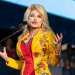 Final Video Drops: The Line Everyone Repeated Singer performing on stage in a bright yellow floral jacket