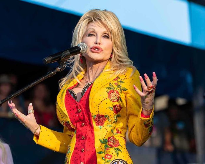 shutterstock_1596680992 Singer performing on stage in a bright yellow floral jacket