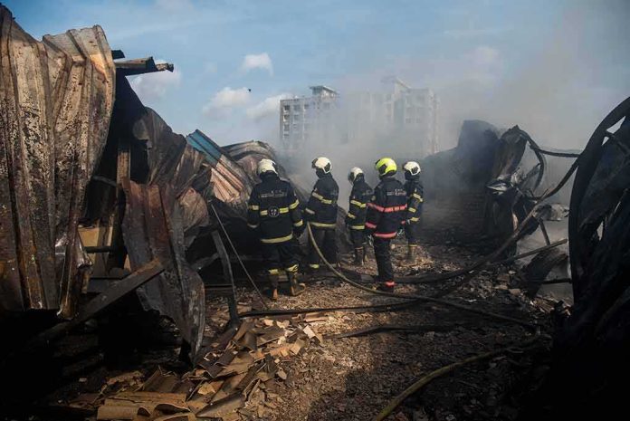 shutterstock_1763668064 Firefighters amid twisted metal and smoke at a disaster site