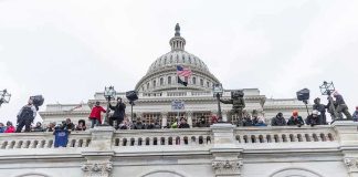 Senate Vote Puts AG Nomination at Risk Protesters gathered on the steps and balcony of a domed government building