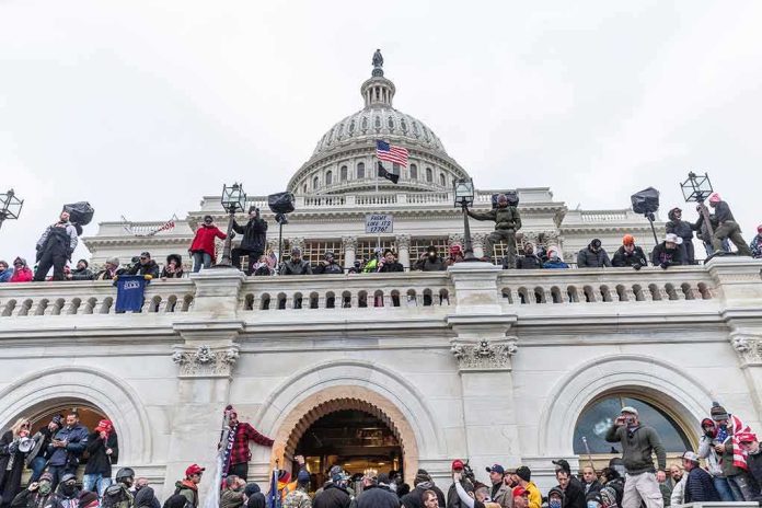 shutterstock_1889190775-1 Protesters gathered on the steps and balcony of a domed government building
