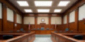 Badge Lies, Freedom Lost—Case Blows Up Empty courtroom with wooden benches and judge's bench