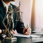 Salon Showdown Sparks Discrimination Firestorm Lady Justice statue on a lawyer’s desk