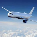 Passenger airplane flying above clouds