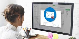 Woman using desktop computer with email warning popup