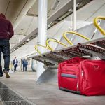 Red duffel bag on a station platform