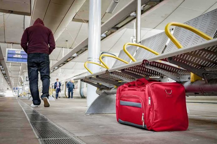 shutterstock_624395705 Red duffel bag on a station platform
