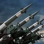 Surface-to-air missiles mounted on launchers against a stormy sky