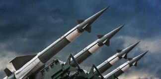Surface-to-air missiles mounted on launchers against a stormy sky