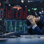 Wall Street Cheers ‘AI Cuts’ — Workers Axed Trader stressed out by multiple declining stock charts.