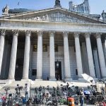 Federal Rebuke Stops Trump’s Voter Purge Push Reporters and photographers gathered outside a neoclassical courthouse
