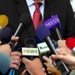 CBS Star Hit With Explosive Lawsuit Press microphones surround a suited spokesperson