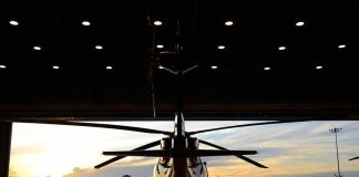 Helicopter in a hangar at sunset