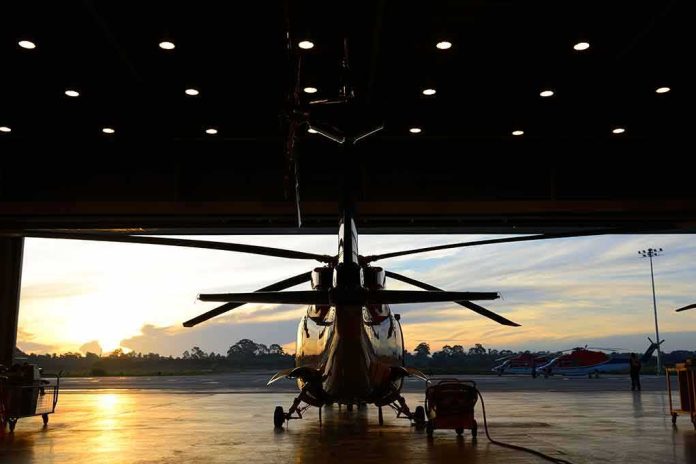 shutterstock_110965106 Helicopter in a hangar at sunset