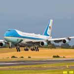Airplane landing on runway with landing gear extended