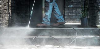 Worker pressure washing outdoor steps