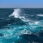 Mexico Mudslide Danger – Polo Roars Offshore Ocean waves crashing with white spray under a clear blue sky