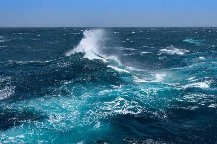 shutterstock_1167157960 Ocean waves crashing with white spray under a clear blue sky