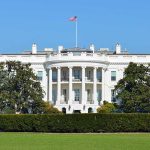 The White House vs. Anthropic — America’s Most Powerful AI at the Center The White House with the American flag flying in front