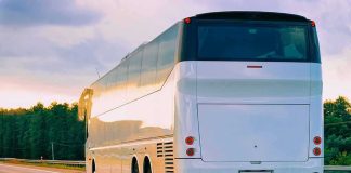 Work-Zone Chaos: Coach Topples In Alps White coach bus driving on a highway at sunset