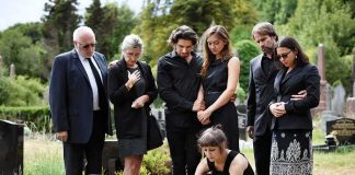 Celebrity Heir Dies In Rehab – Autopsy Pending Mourners gathered at a graveside placing flowers