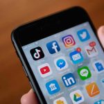 AI Age Checks Enforce Total Ban Smartphone screen with social media and messaging apps
