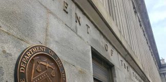 U.S. Treasury building exterior with bronze seal on stone wall