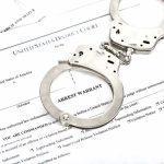 UK Piles On — Tates Cornered In Court Handcuffs on arrest warrant documents
