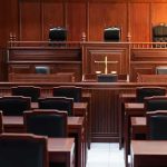 Vigil Turned Subversion — Judges Drop Hammer Empty courtroom with wooden benches and judge's bench