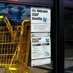 70M Gamble: Anyone Eats Cheaper Yellow shopping carts beside store entrance with SNAP benefits sign