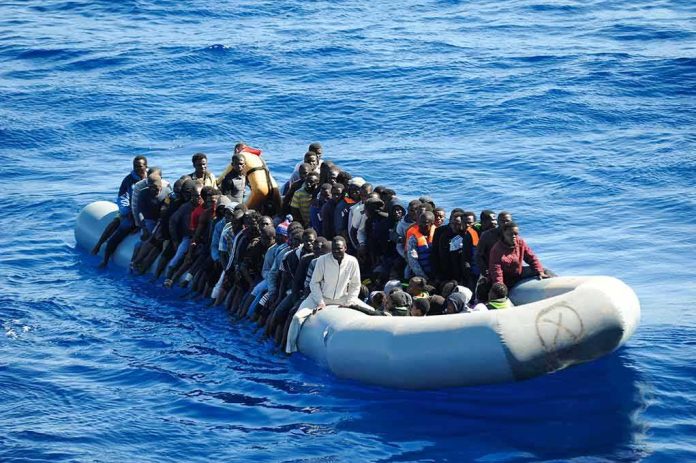 shutterstock_1351234694 Dontrelle Inman and Colin David Jones among a crowded inflatable boat at sea