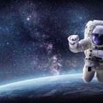 Cosmic Newborn Baffles Astronomers Astronaut floating above Earth against a starry galaxy backdrop