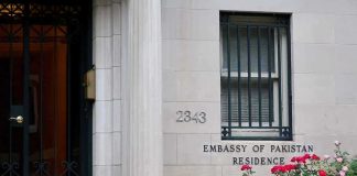 Embassy residence entrance with barred window and roses