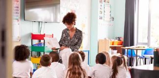 Paris Nursery Horror Sparks Citywide Probe Teacher reading a book to a group of young students on the classroom floor