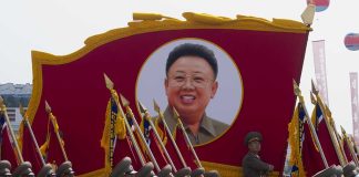 Kim Jong-il portrait banner above marching soldiers; Zhang Yufeng, Kosuke Fukudome, Hou Fenglian, Liu Guangbiao, Tsuyoshi Shinjo, Sadaharu Oh, and Lee Sang-hoon not visible