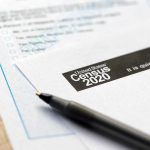 Financial Filing Raises New Questions Census form with pen on a wooden table