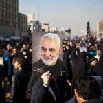 Assassination Chatter Explodes—Missiles Mentioned Qasem Soleimani portrait held aloft in a crowded street gathering
