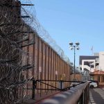War Materials Move Inside The Wire Razor wire along a prison perimeter fence