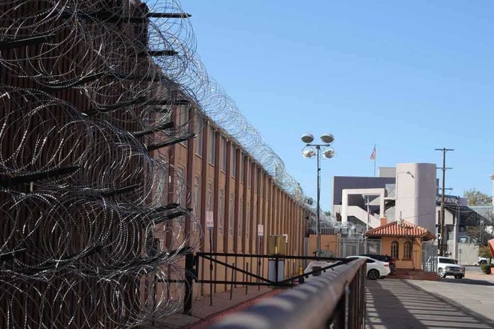 shutterstock_1630378858 Razor wire along a prison perimeter fence