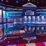 Fertility Quip Ignites Primetime Backlash Televised debate stage with multiple podiums and bright red, white, and blue lighting